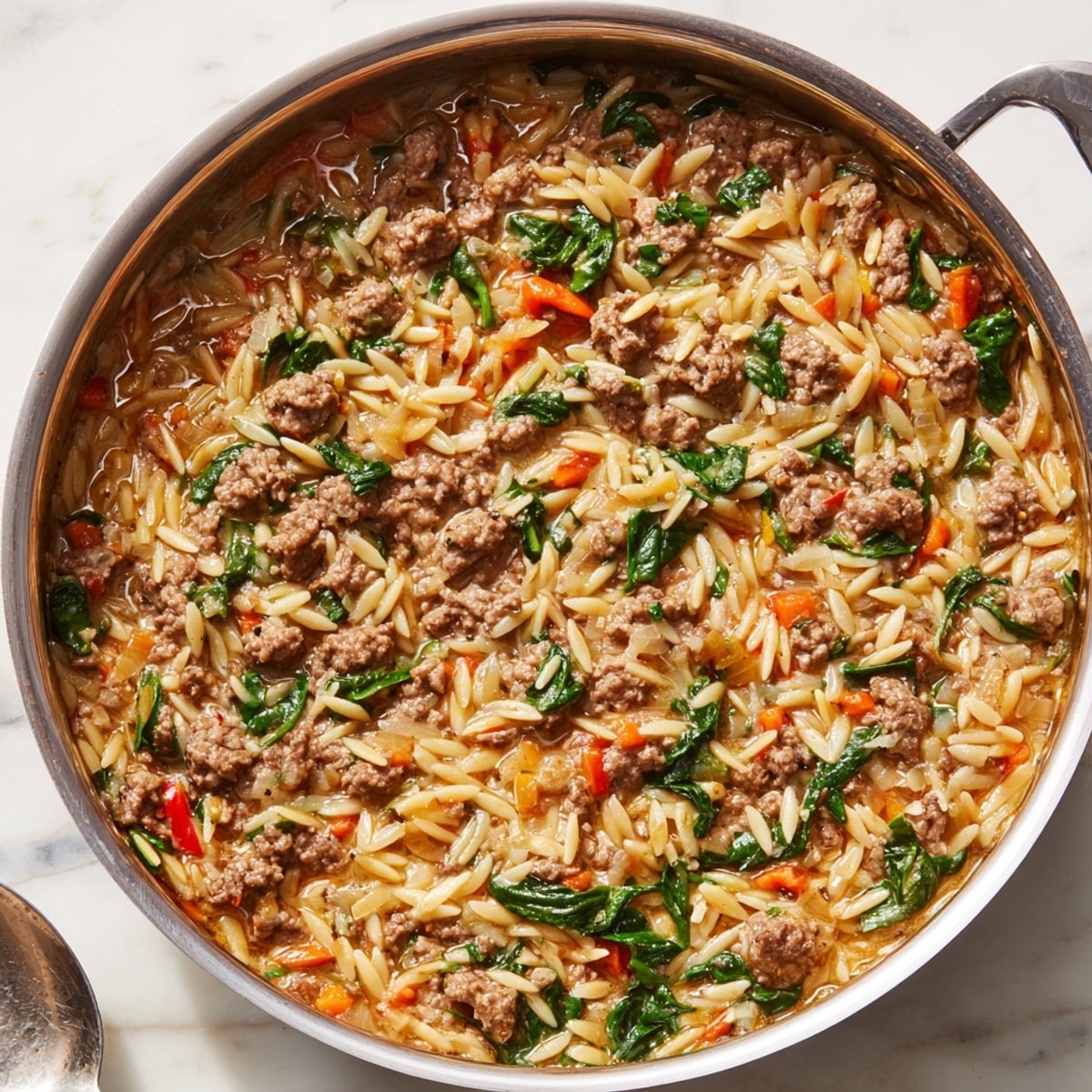 A forkful of savory One-Pot Beef Orzo, showing the creamy, cheesy texture.