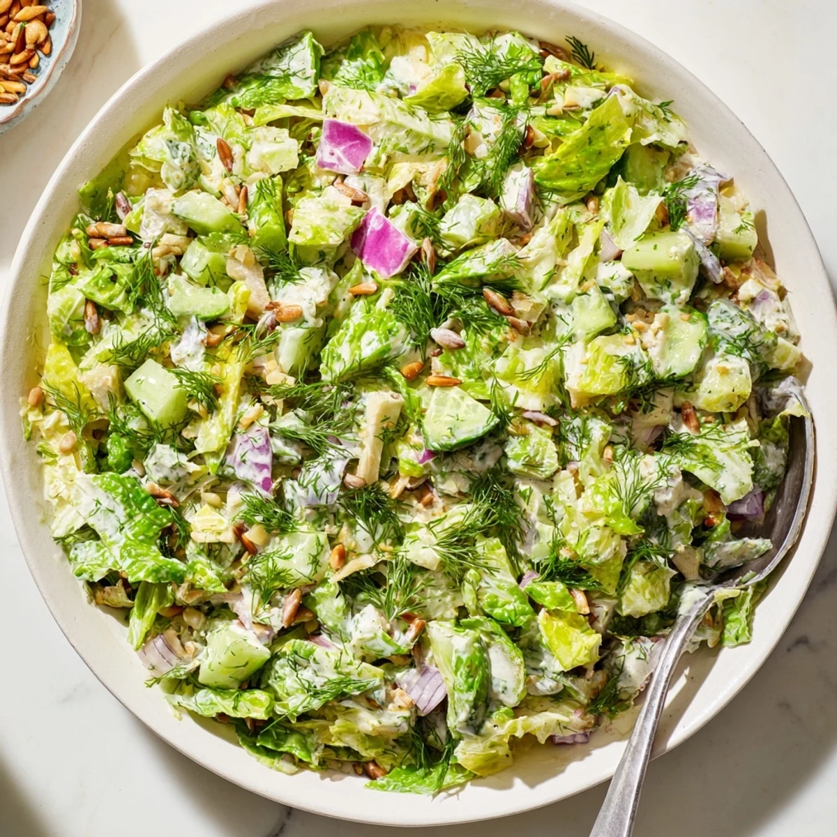 Vibrant Dill Pickle Chopped Salad Crunch topped with sunflower seeds and crispy onions.  