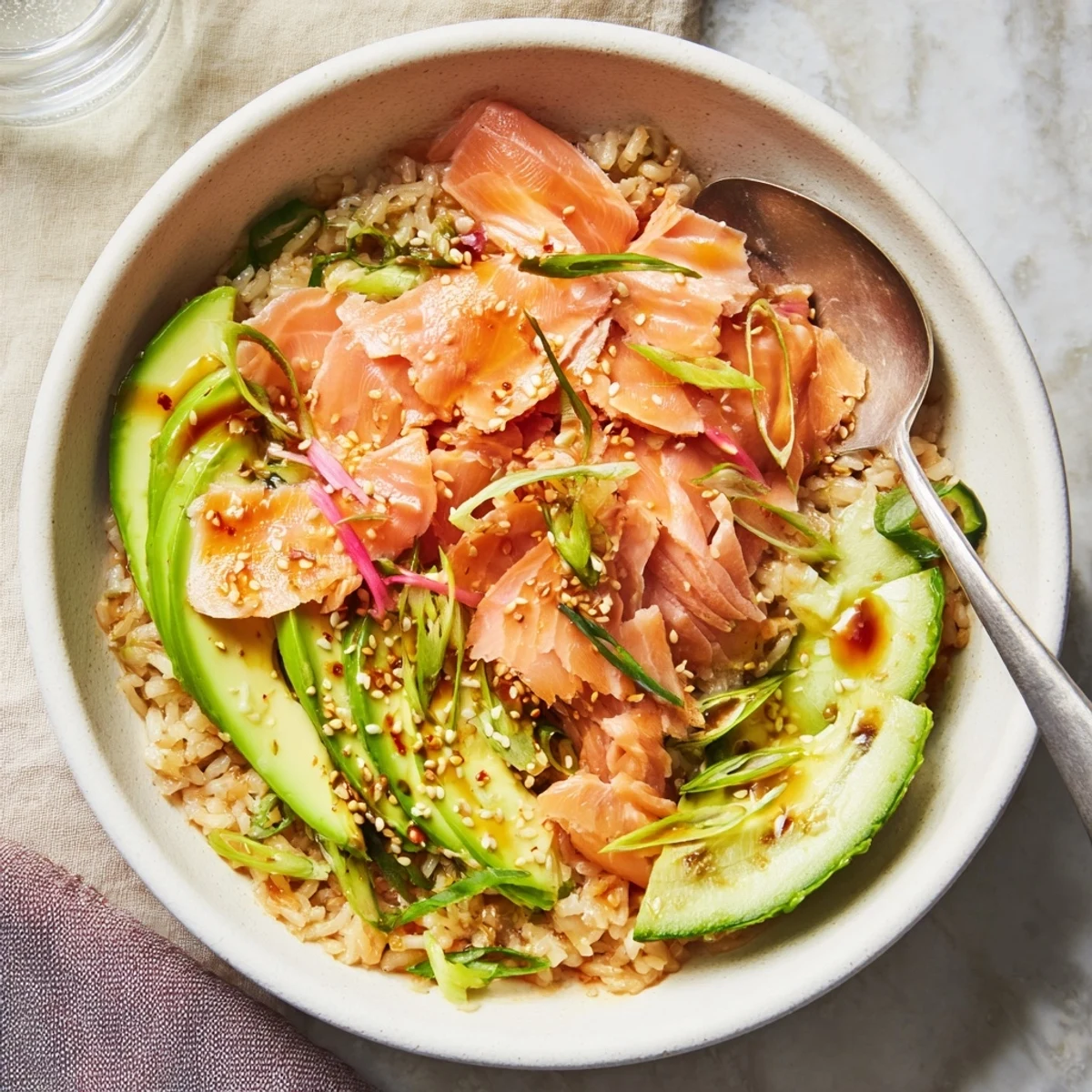 Delicious Leftover Salmon & Rice Bowl packed with vibrant avocado and cucumber slices.  