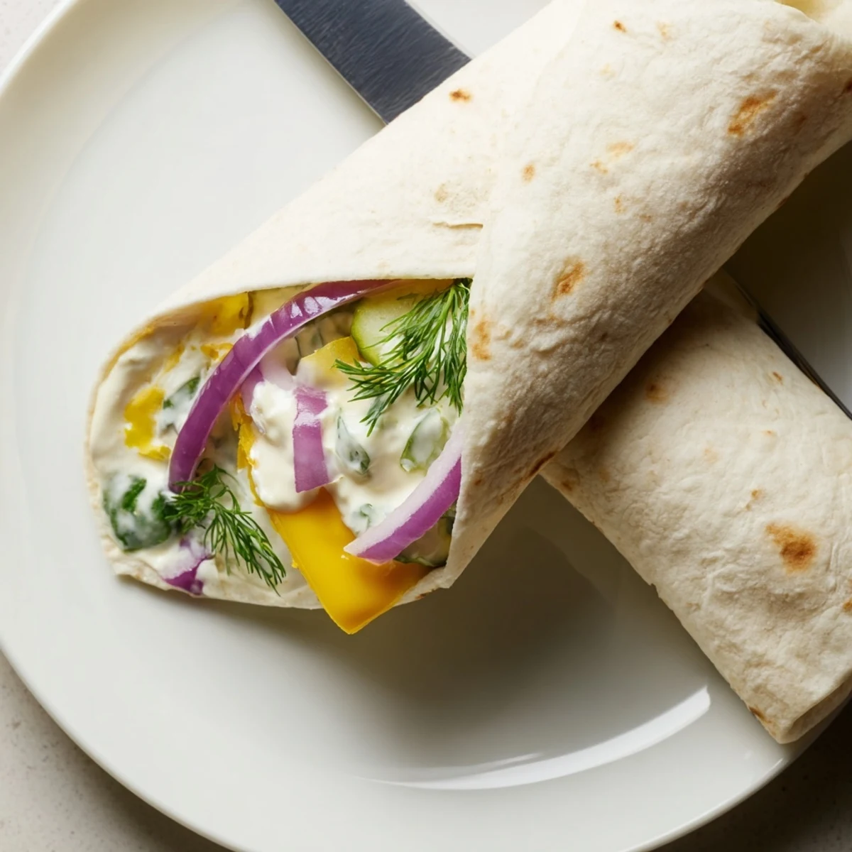 Delicious pickle-in-a-blanket bites, combining tangy dill and soft tortillas.  