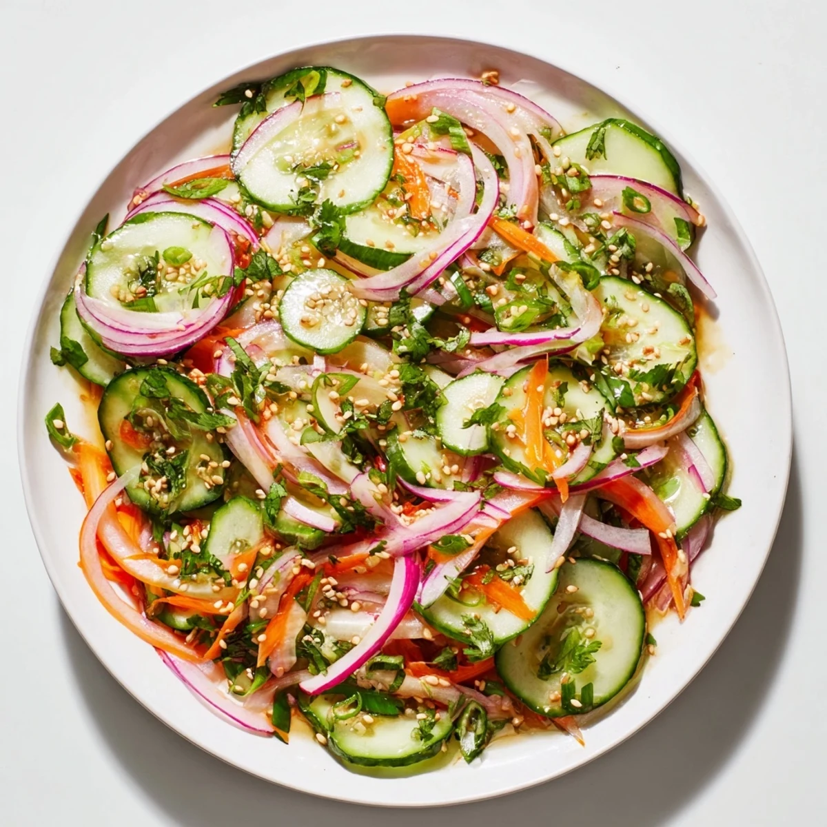 Vibrant cucumber salad remix garnished with sesame seeds, perfect for summer meals.  