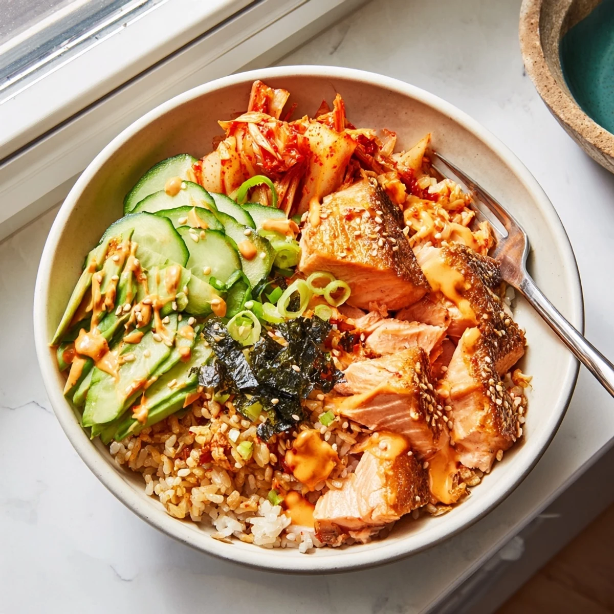 Delicious Crispy Salmon Rice Bowl featuring golden rice and crunchy garlic bits.  