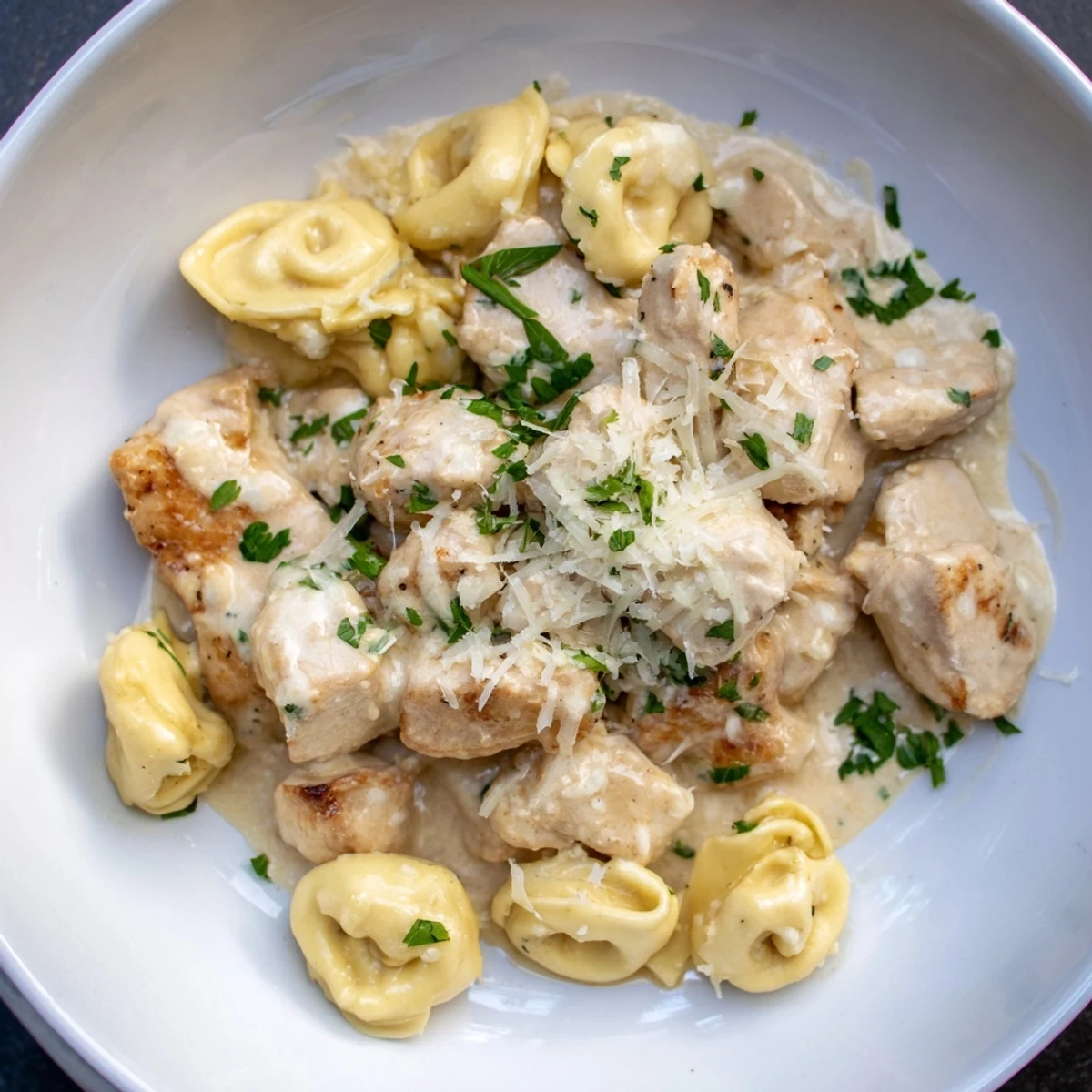 Creamy Zesty Cajun Garlic Parmesan Chicken Tortellini, a flavorful pasta dish with seasoned chicken and fresh parsley.