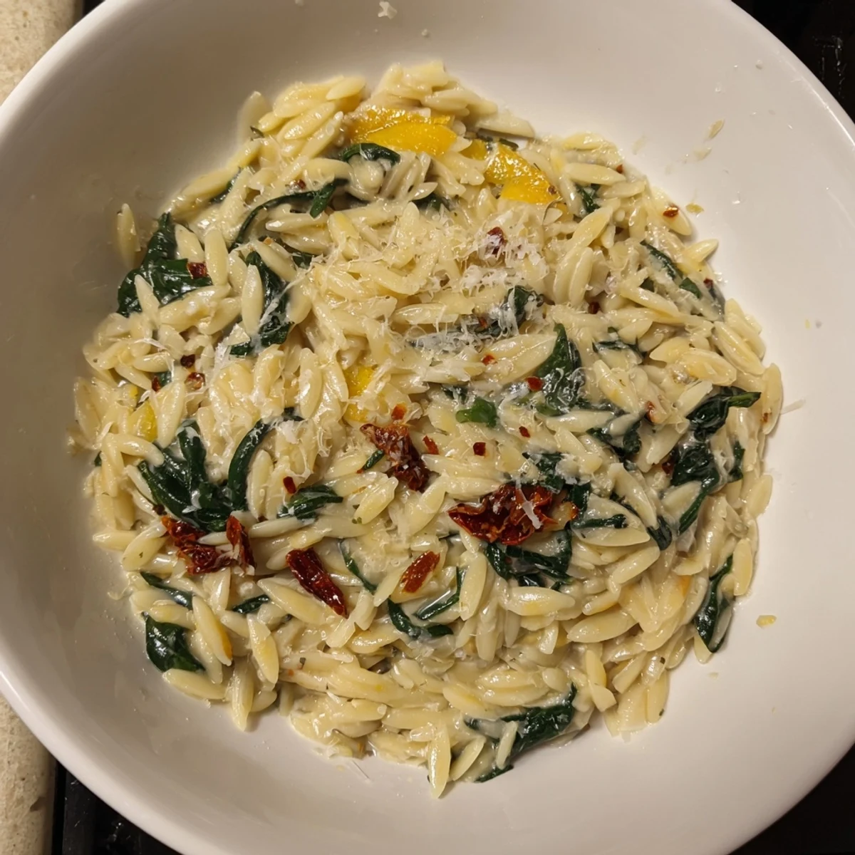 Creamy Tuscan Orzo Bowl: A vibrant photo shows the creamy pasta with sun-dried tomatoes and spinach.