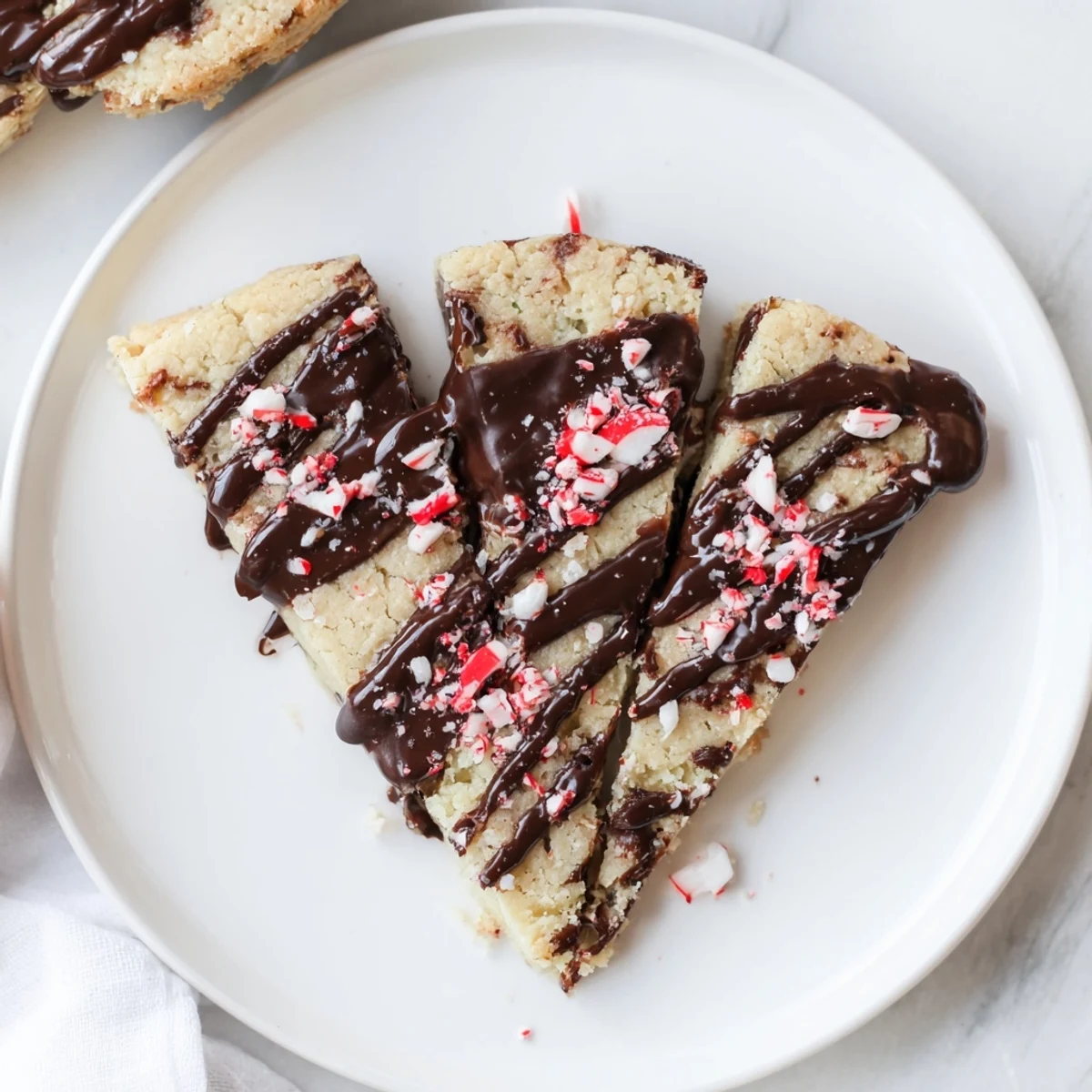 Freshly baked chocolate peppermint shortbread wedges, showing a close-up of the delicious chocolate drizzle.