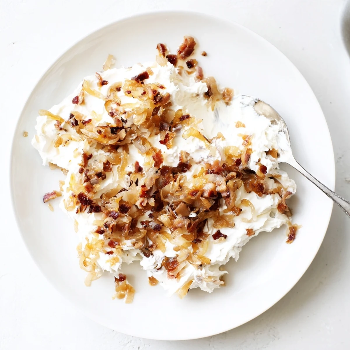 Golden caramelized onion and bacon dip, a creamy, savory appetizer perfect for sharing.