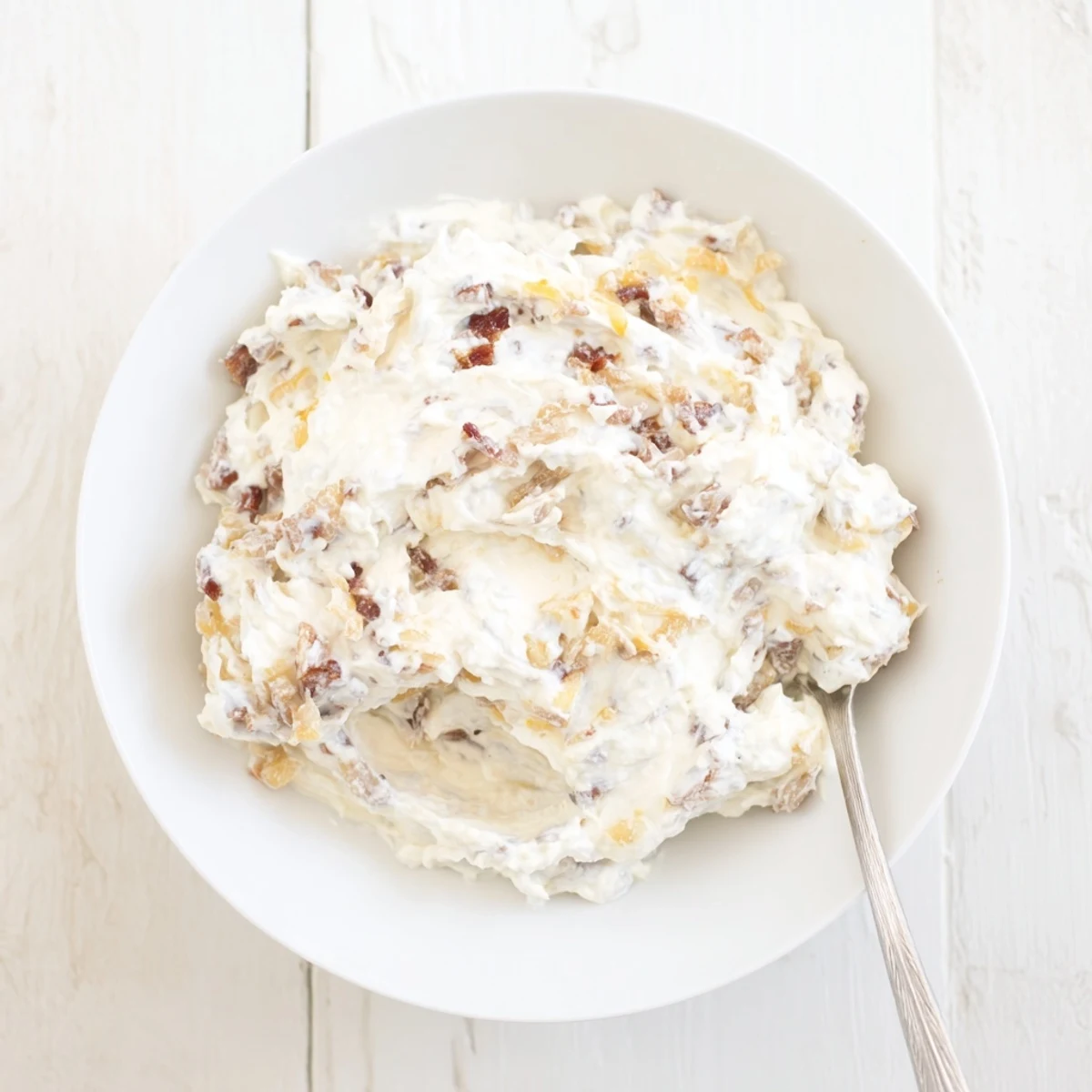 This close-up shows the rich texture of Caramelized Onion and Bacon Dip served with chips.