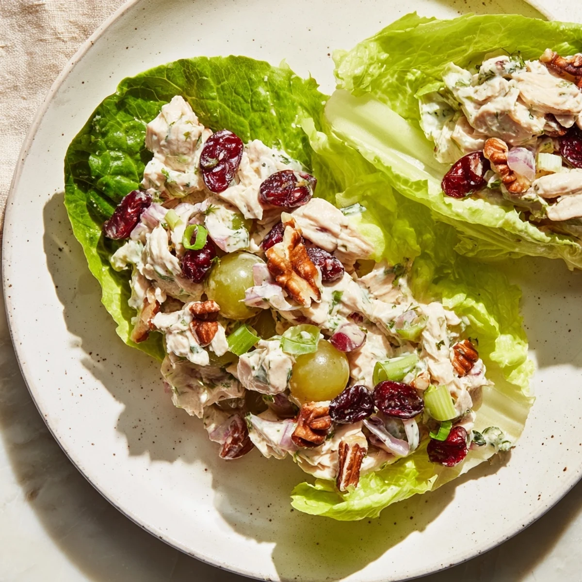 Bright, colorful photo of the festive chicken salad cups, ready to enjoy with fresh lettuce.