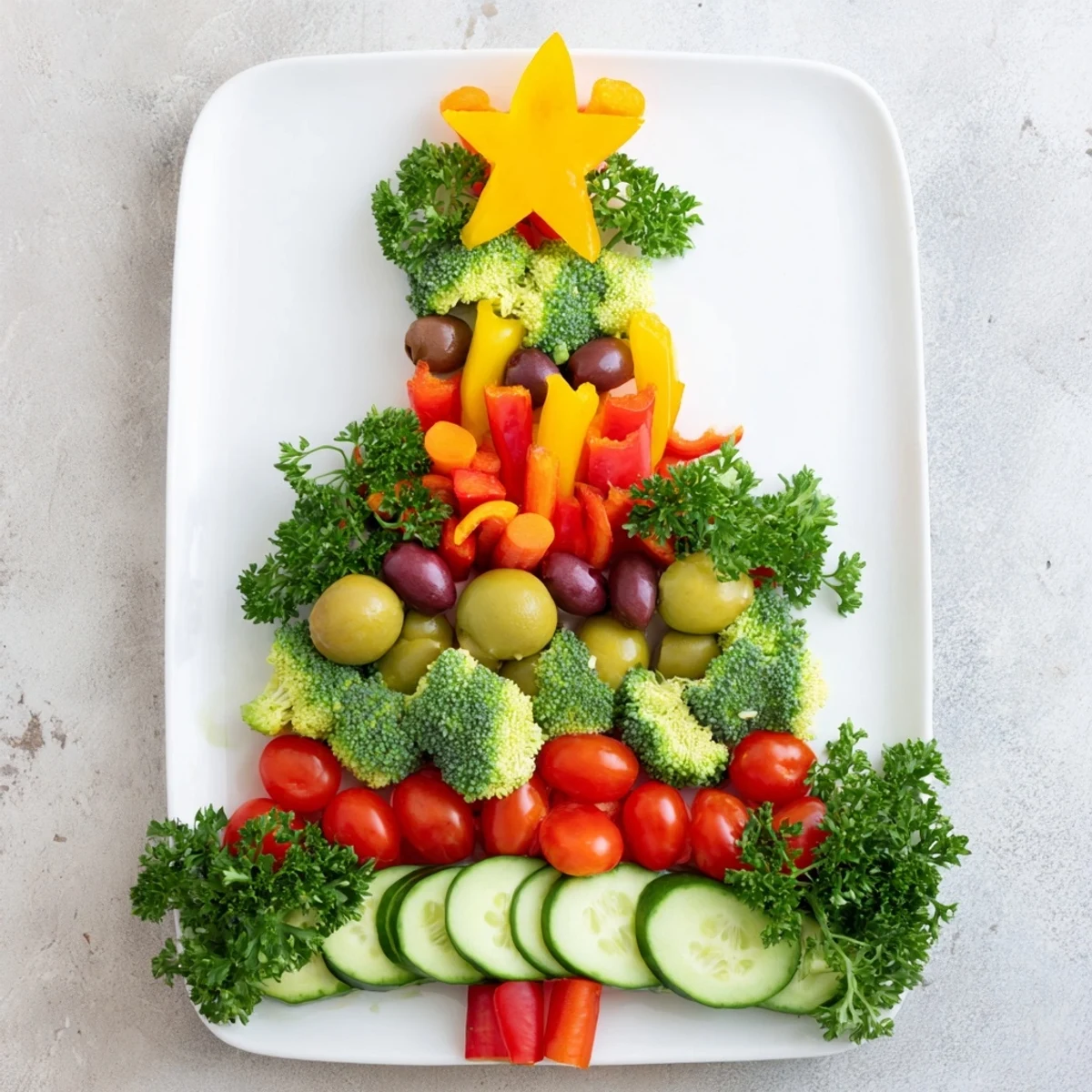 A visually stunning Healthy Christmas Veggie Platter Tree, complete with a star and olive ornaments.