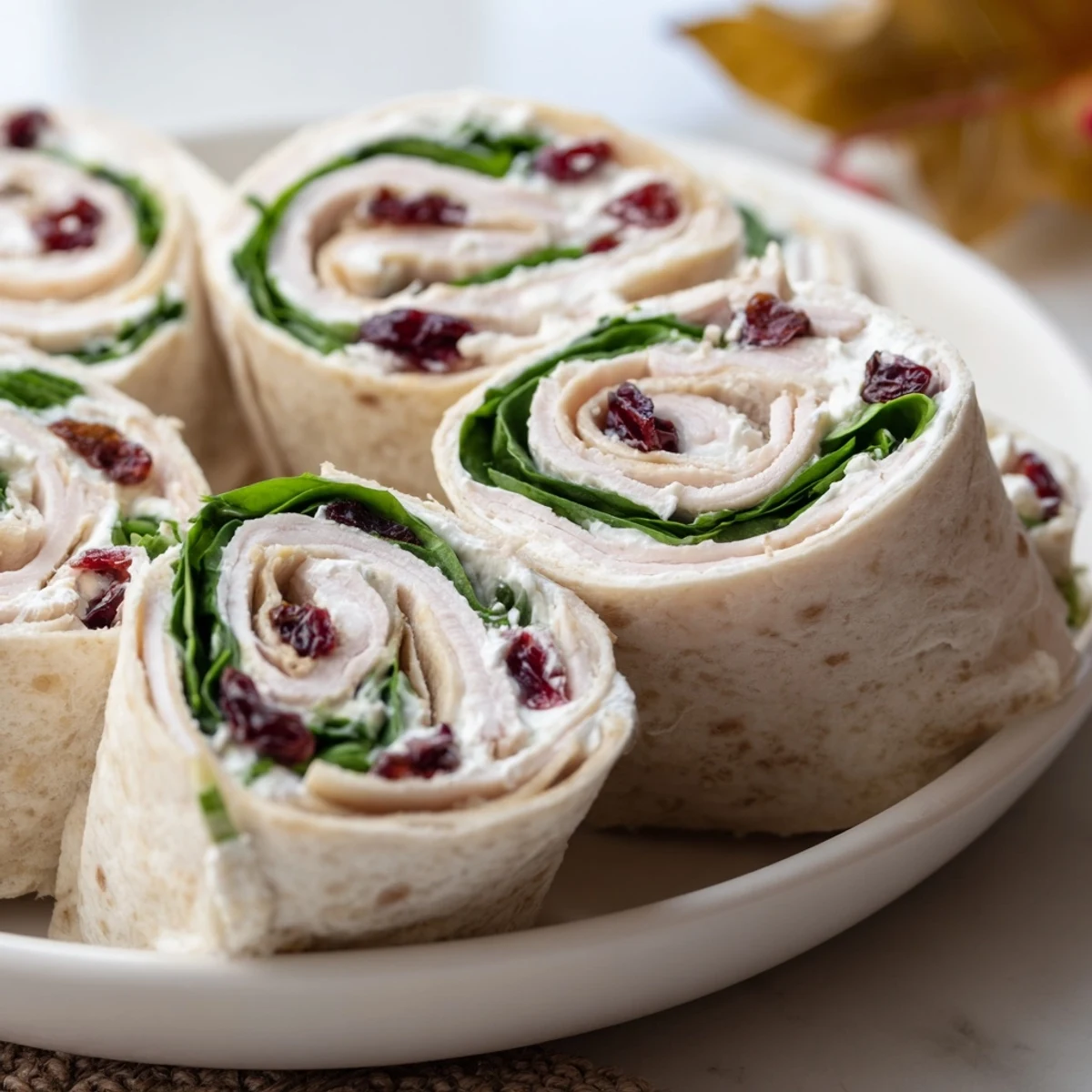 A platter of vibrant Simplified Turkey Cranberry Pinwheels, ready to serve with refreshing flavors.