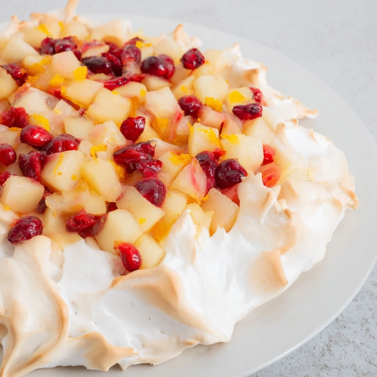 Golden-brown meringue crowns a baked Cranberry and Pear Snowscape, a perfect winter dessert served warm.