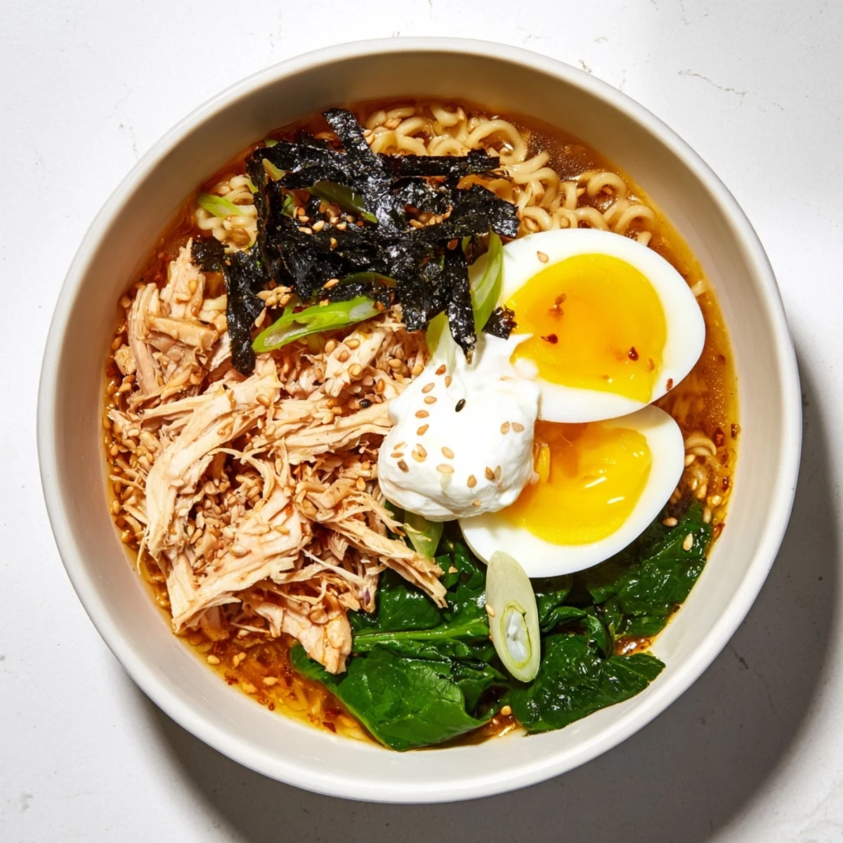 Close-up of savory Chicken Ramen with Kewpie Mayo; a quick meal with sliced chicken and nori strips.
