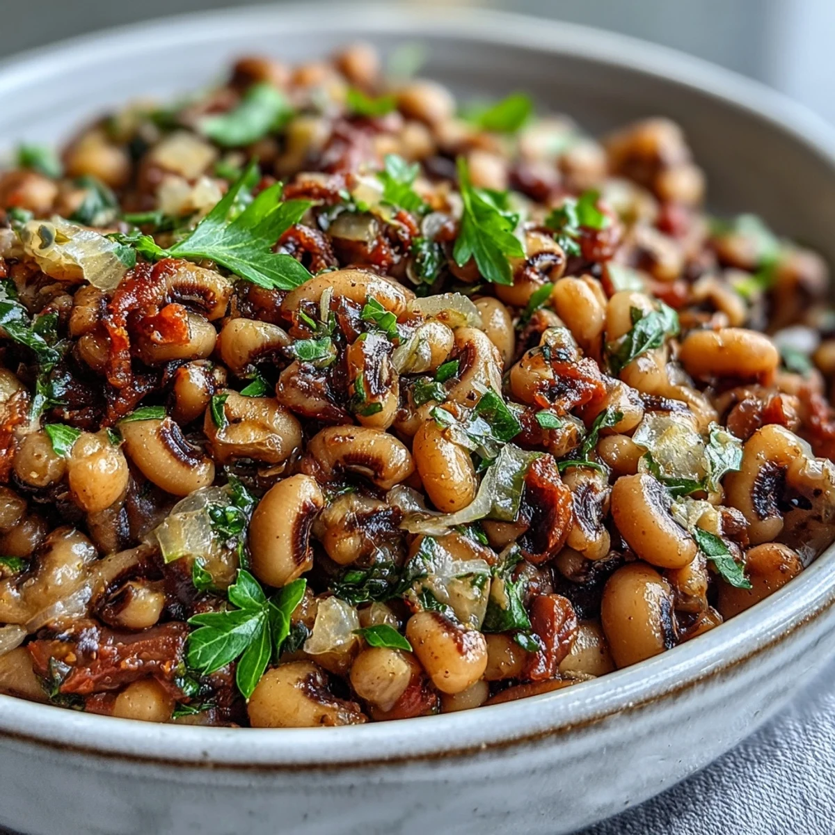 Savory Frozen Black-Eyed Peas simmered in a rich, smoky broth with diced tomatoes and fresh parsley garnish, served in a rustic bowl.
