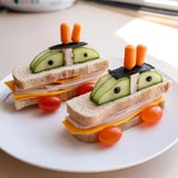 A colorful Road Trip Ready Car-Shaped Lunch, presented with fresh grapes and carrots for a balanced meal.