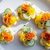 Vibrant Fairy Garden Flower Shaped Snacks, ready to eat, arranged on a plate for a children's party.