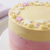 This delightful Château de Princesse Cœurs et Étoiles cake, a layered dessert ready for celebration, is adorned with edible stars.