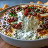 Creamy cheese dip topped with savory chorizo, jalapeños, and avocado, perfect for Cinco de Mayo parties and celebrations.
