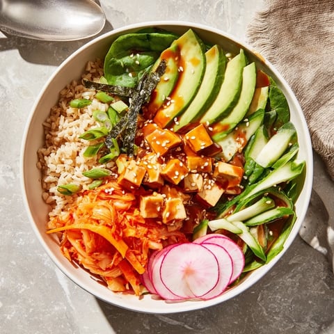 Vibrant fermented vegetable bowl topped with tangy kimchi and fresh greens.  