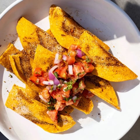 Golden, crunchy Air-Fryer Tortilla Chips served alongside vibrant, chunky homemade salsa for dipping.