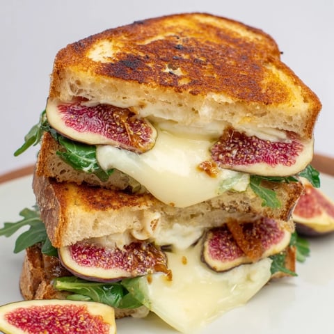 Golden-brown Fig, Brie & Arugula Grilled Cheese, oozing with melted Brie and sweet fig.