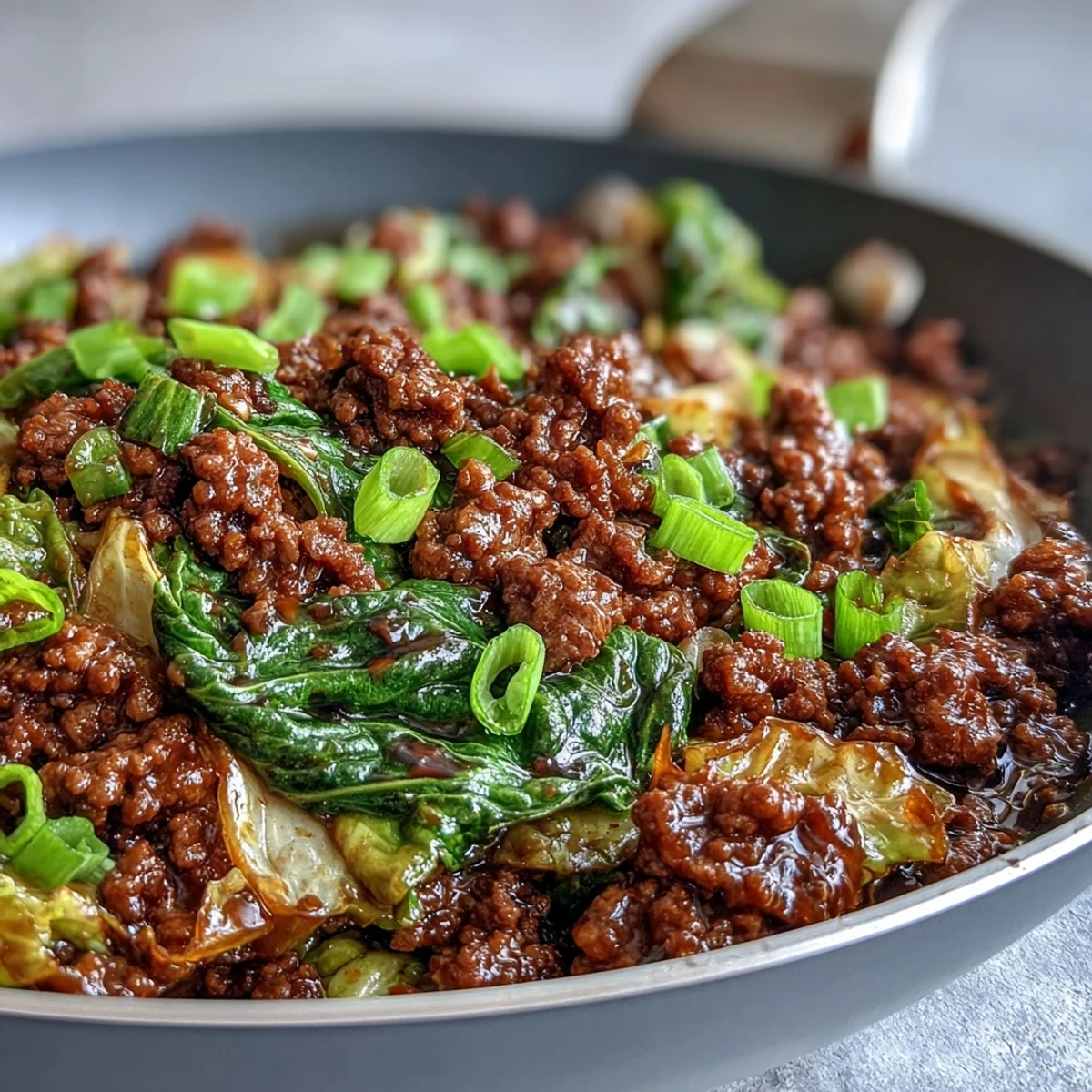 Chinese Ground Beef and Cabbage Stir-Fry served hot with steamed rice, featuring savory beef and crisp green cabbage.