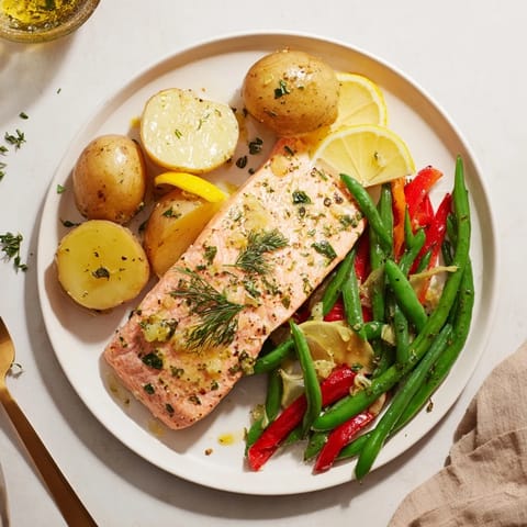 Colorful Lemon Herb Salmon & Potato Sheet Pan dinner featuring fresh herbs and roasted perfection.  
