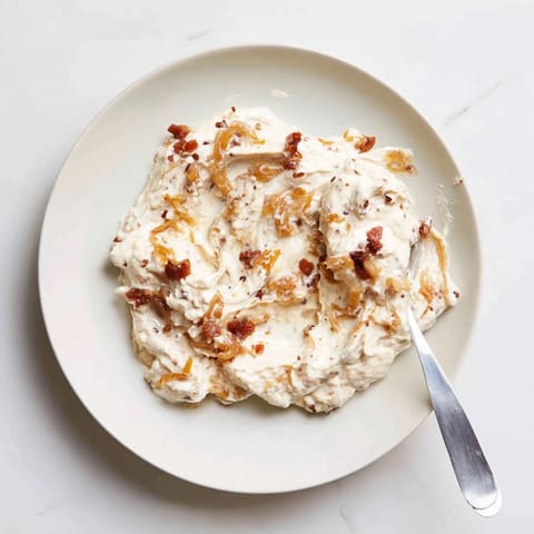 Smoky bacon bits and sweet onions blend beautifully in this easy Caramelized Onion and Bacon Dip.