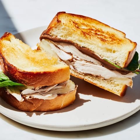 Visualize the rich layers of a Nutella grilled cheese with chicken, perfect for a cozy lunch.