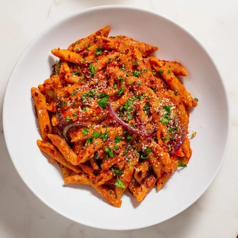 This One-Pot Diavola Spicy Pasta offers a delightful, aromatic blend, perfectly seasoned with red pepper flakes.