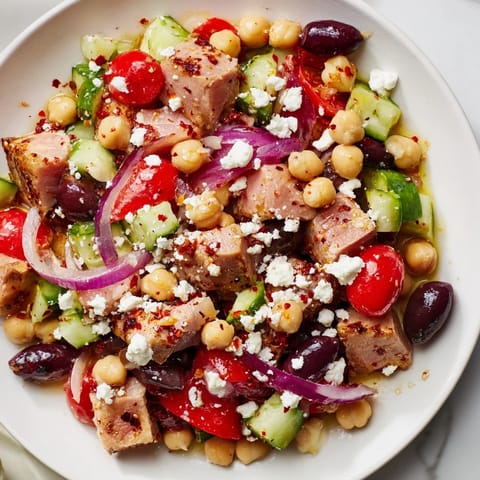 Flavorful Tuna Chickpea Salad, overflowing with fresh herbs and a zesty lemon dressing, awaits.