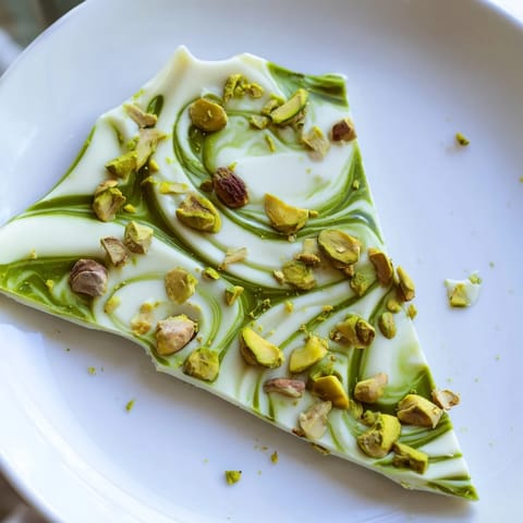 Homemade Pistachio Matcha White Chocolate, a perfect treat: white chocolate bark studded with vibrant green matcha and nuts.