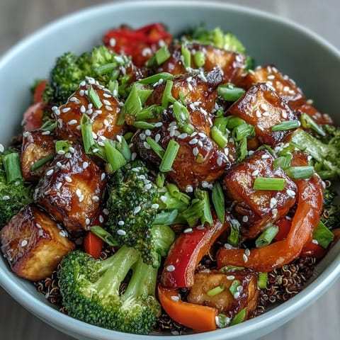 A vibrant bowl of Quinoa Vegetable Teriyaki featuring stir-fried broccoli, bell peppers, and carrots ready to enjoy.