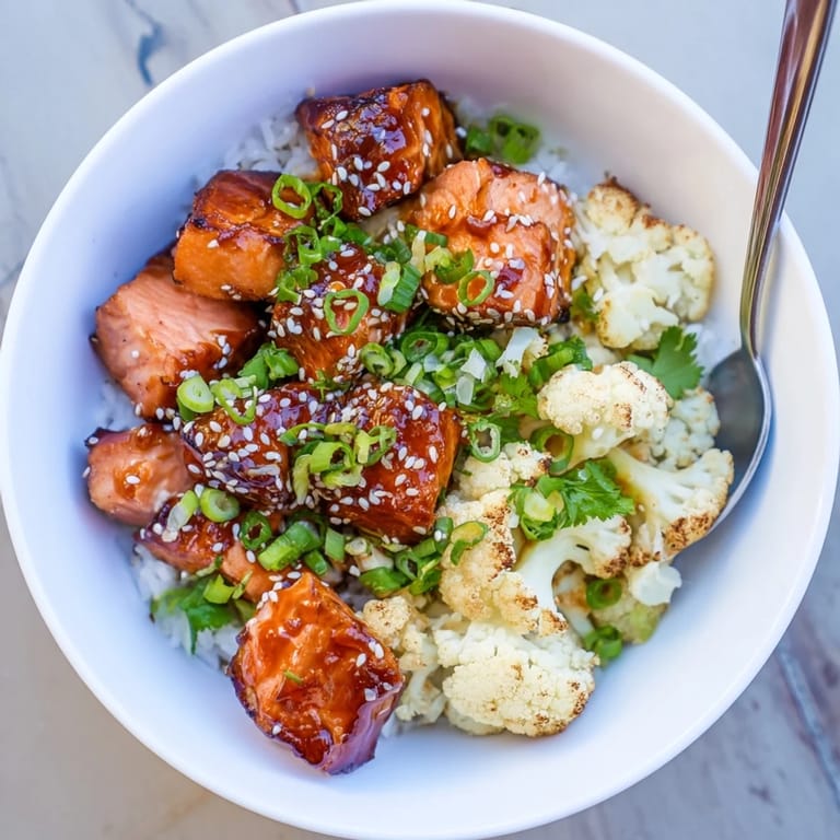 Delicious Sriracha Honey Salmon Bowls with spicy glaze, tender salmon, and roasted veggies.
