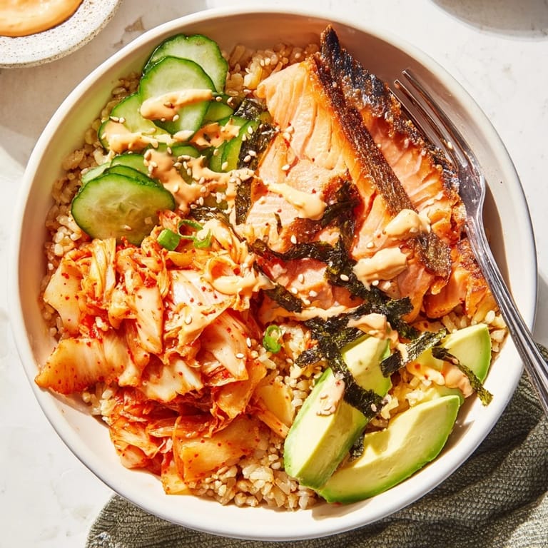 Flavorful Crispy Salmon Rice Bowl garnished with sesame seeds and vibrant vegetables.