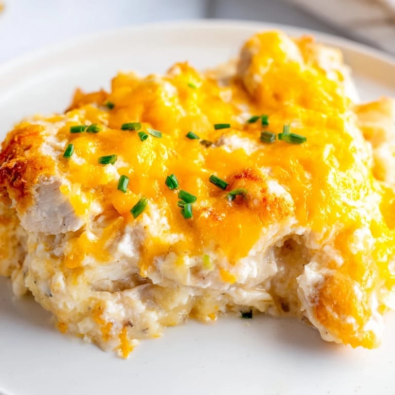 Juicy chicken breasts smothered in ranch and cheddar cheese, a delicious Cheddar Ranch Chicken Bake.