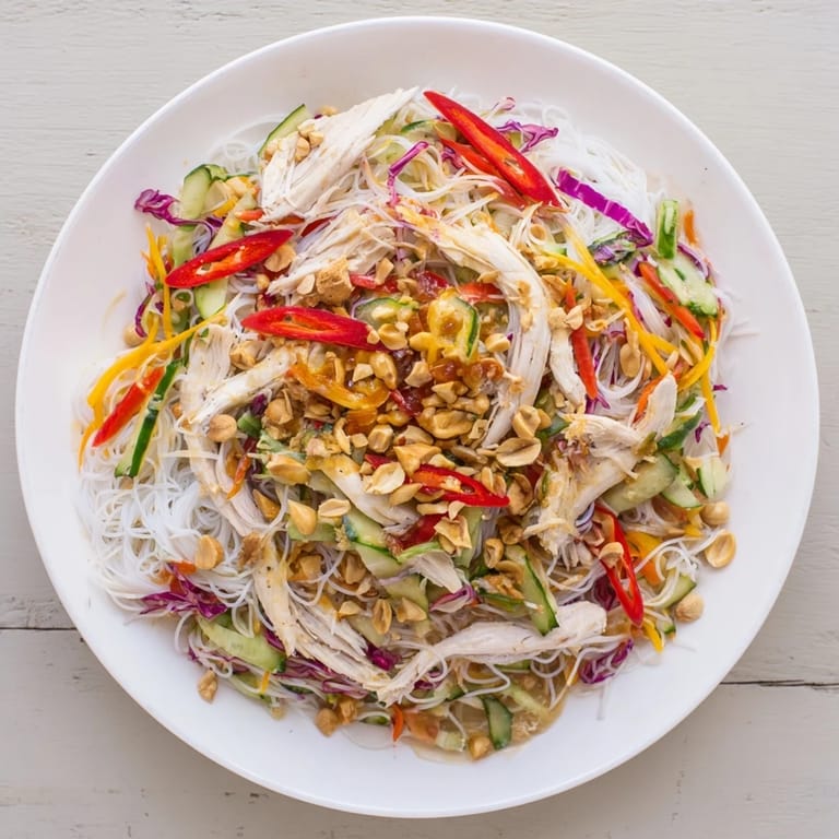 Enjoy a refreshing plate of Vietnamese Crunch Noodle Salad with peanuts, perfect for a light meal.