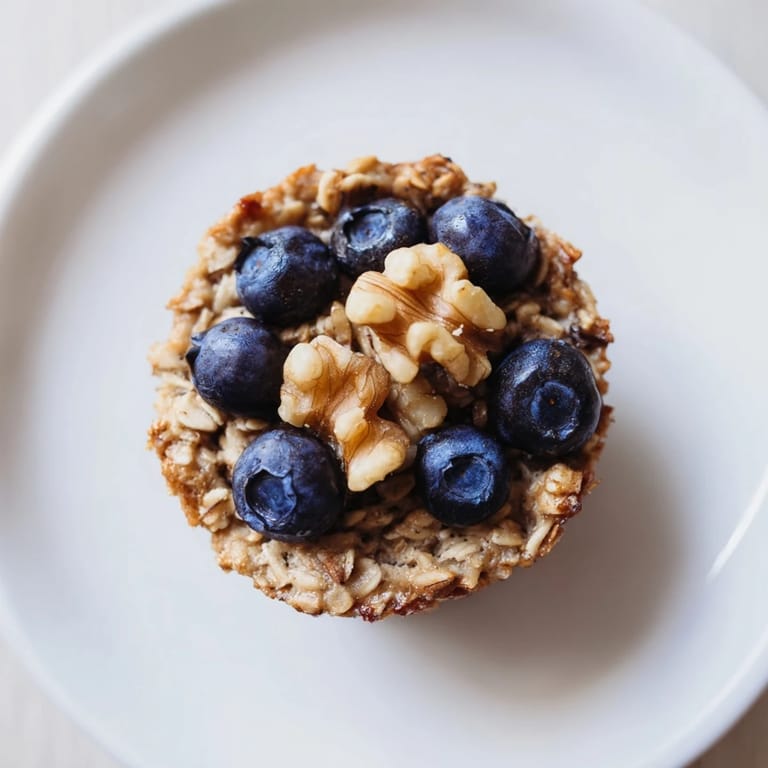 These portable baked oatmeal cups, chewy and sweet, are a delightful make-ahead breakfast option.
