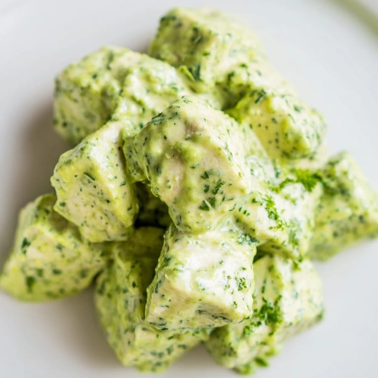 Gluten-free Green Goddess chicken salad tossed in tangy yogurt dressing, with cucumber, tomatoes, and herbs on a bed of greens.