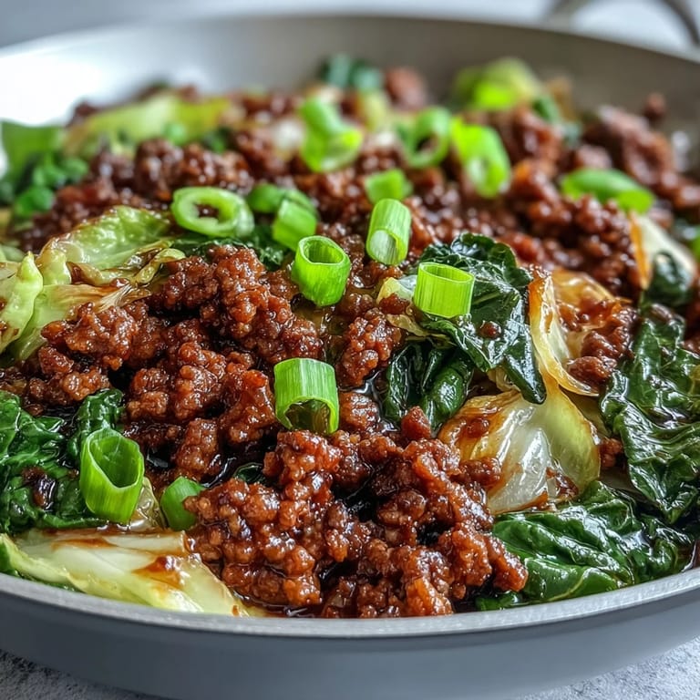 This easy Chinese Ground Beef and Cabbage Stir-Fry recipe is topped with fresh green onions, ready for a low-carb weeknight dinner.