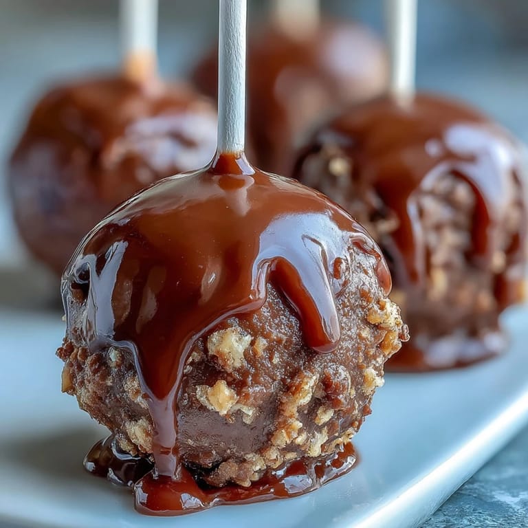 Delicious cake pops decorated in school colors and finished with gold sprinkles, perfect for a festive graduation celebration.