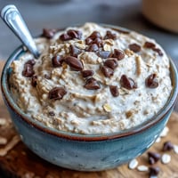 Creamy vegan chickpea cookie dough dip, a no-bake treat with melted chocolate chips.